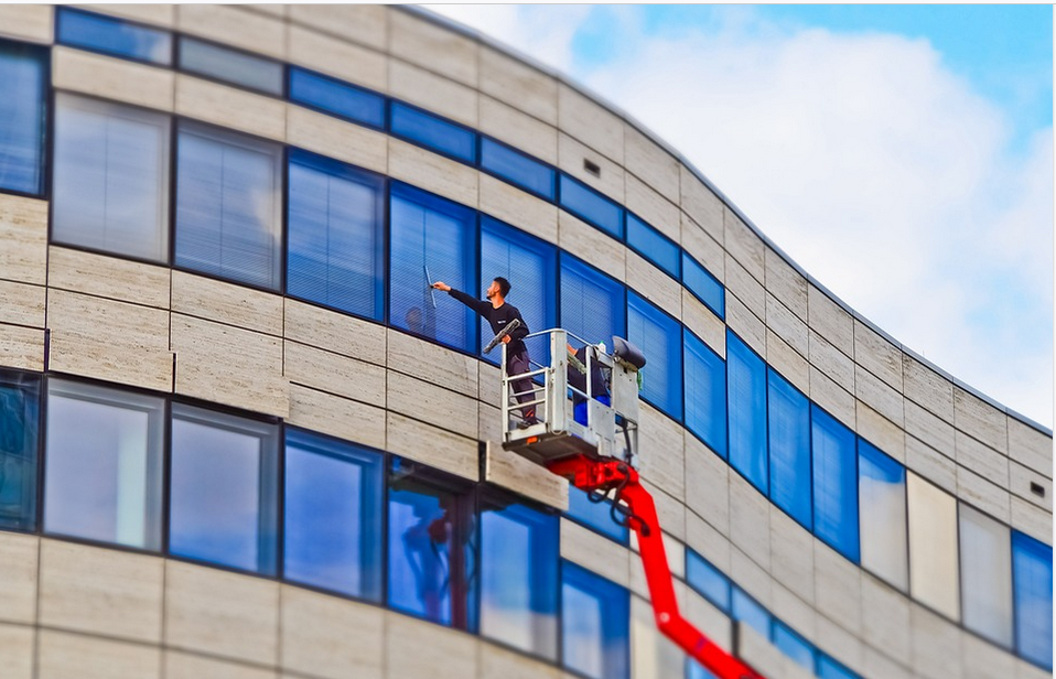 a cleaning company's employee cleaning windows